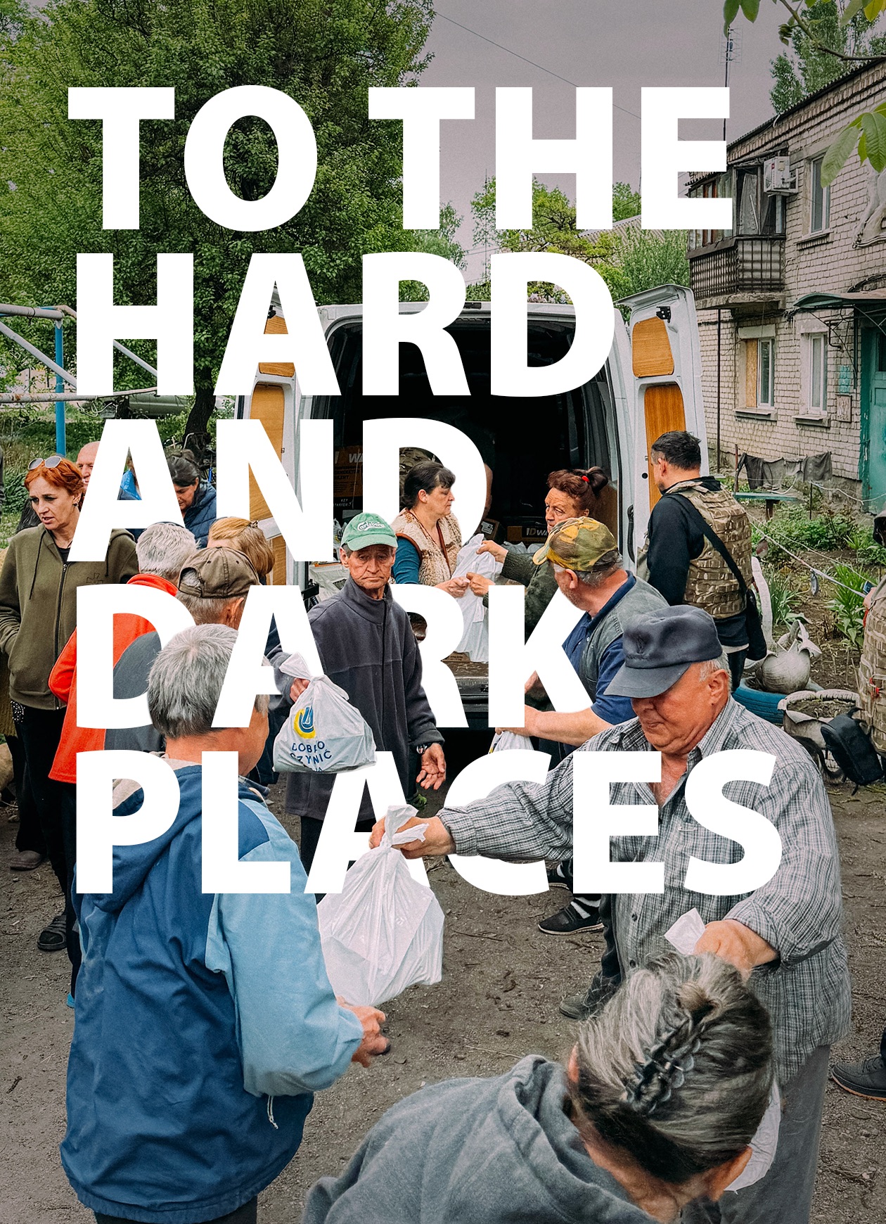 The text: to the hard and dark places is superimposed on an image of relief work in Ukraine