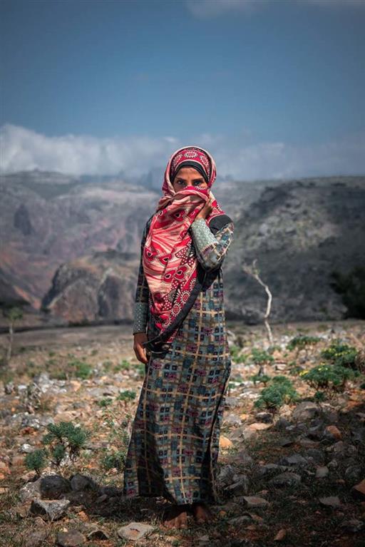 A Yemeni woman covers her face.